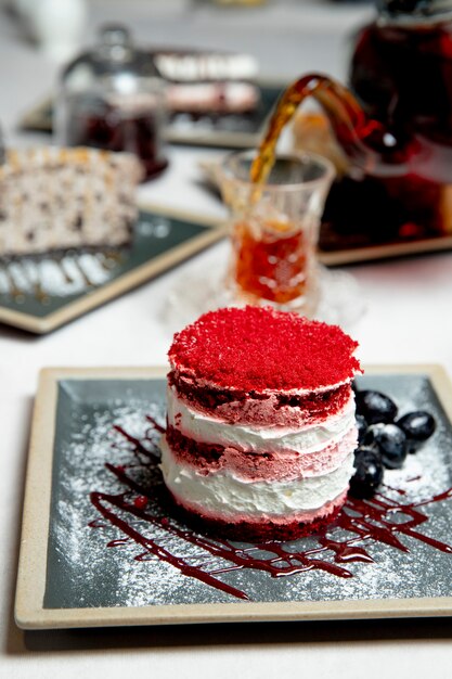 cake with red topping served with tea