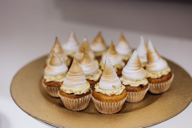 Cakes with cream are served on golden plate