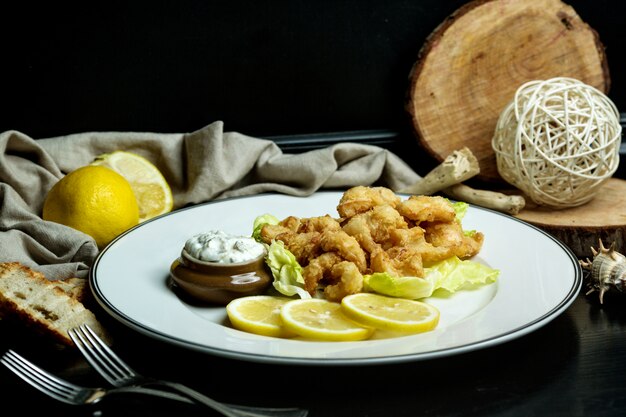 Calamari rings served with lemon and mayonnaise