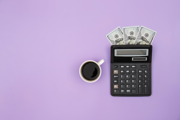 Calculator cup of coffee and dollar bills on colored background flat lay