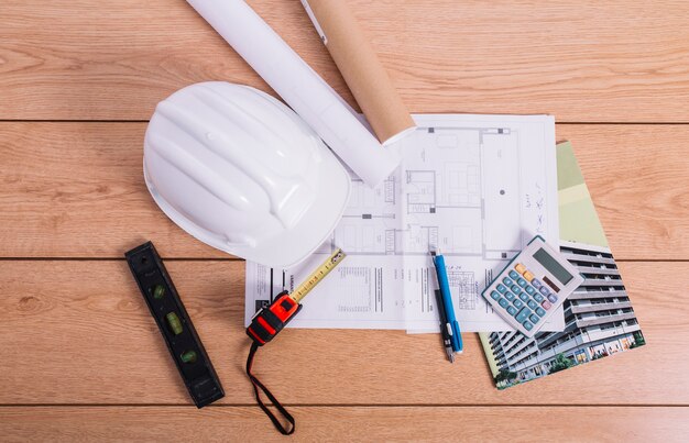 calculator and helmet on blueprint