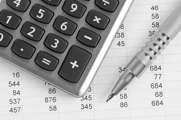 Premium Photo | Calculator and pen on a business background