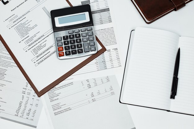 Calculator on several documents and a notebook