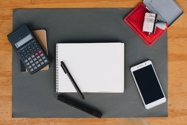 Calculator and smartphone near stationery