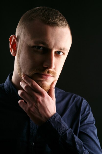 Calm face of bearded man with blue eyes 