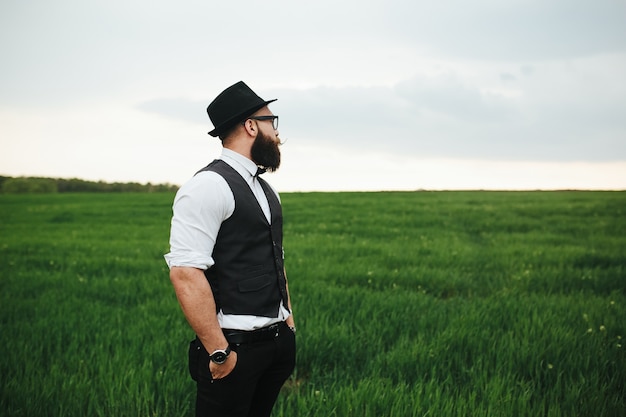 Calm man looking at the green field