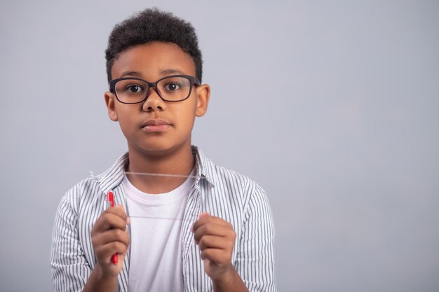 Calm pupil with the slide in his hands looking ahead