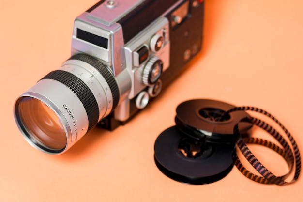 Camcorder with filmstrip on peach colored backdrop