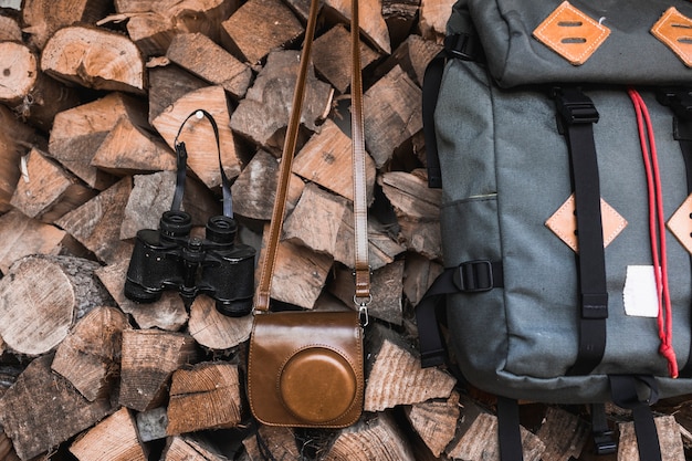 Camera and binoculars near backpack