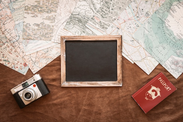 Camera, passport, and blackboard on maps