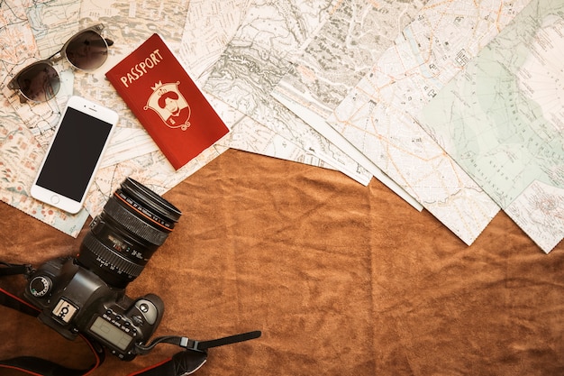 Camera, smartphone and passport on table