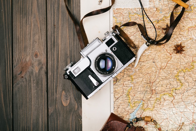 Camera, species lie on old yellow map