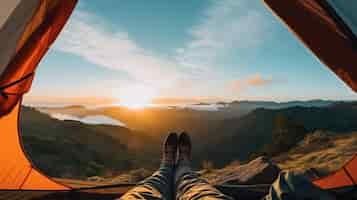 Free photo camper enjoys the mountain view from the comfort of a tent with hiking boots pointing toward the horizon