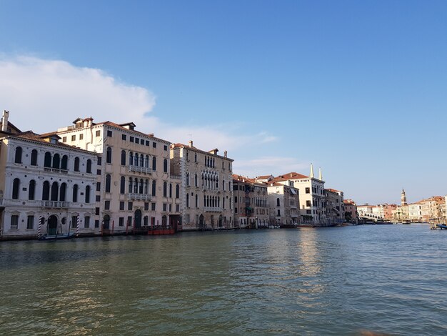 Canal in the middle of buildings under a blue sky in Italy