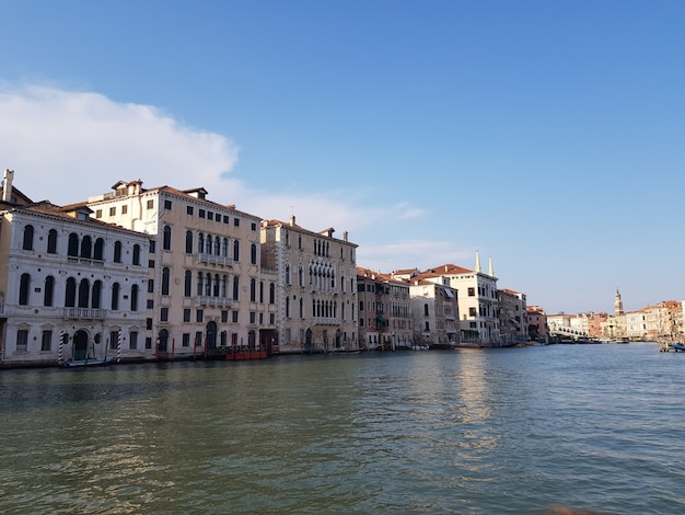 Canal in the middle of buildings under a blue sky in Italy