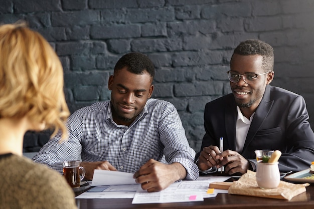 Candid shot of handsome African-American recruiting manager and his assistant