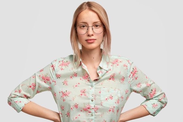 Candid shot of pleasant looking confident female with light hair