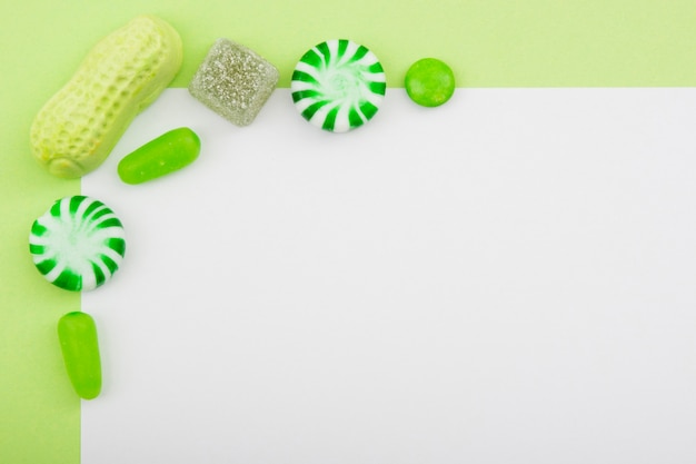 Candies aligned on white table 