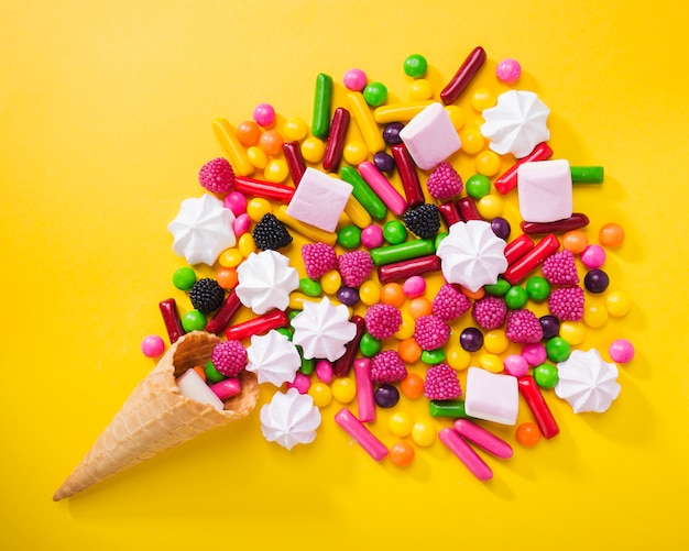 Candies and marshmallows near waffle cone