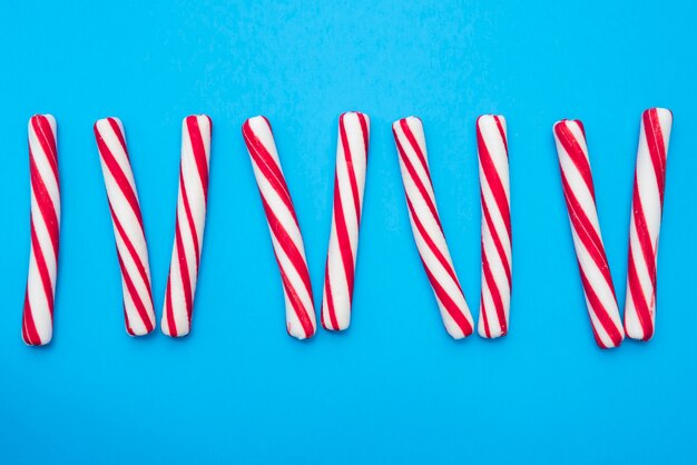 Candies sticks aligned on table 