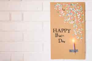 Free photo candle on cardboard with birthday greeting
