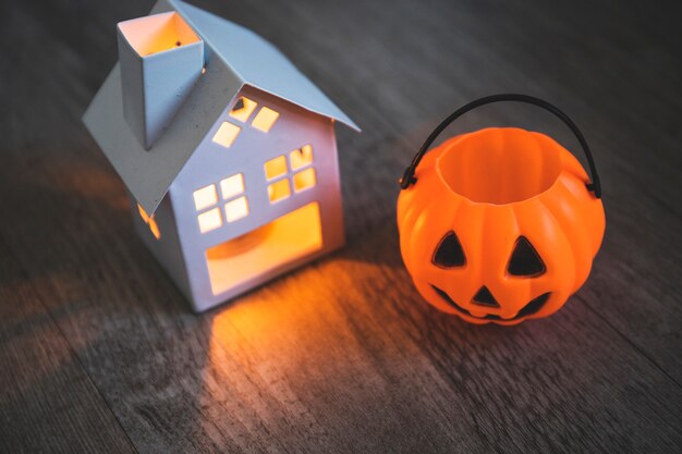 Candle and jack-o-lantern basket on table