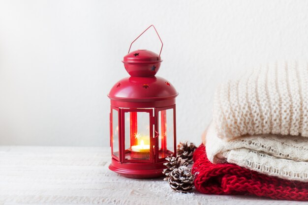 Candle in a lamp with towels next to it