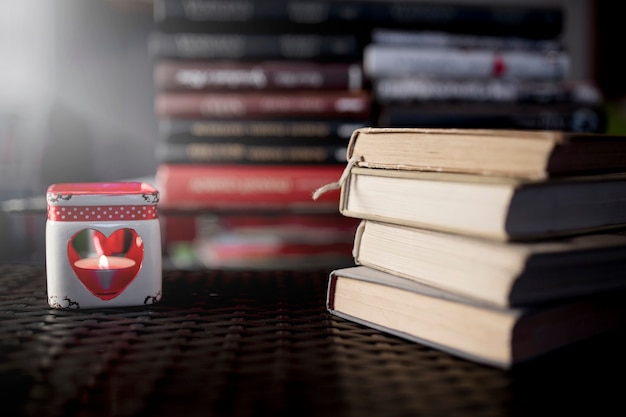 Candle and stacks of books