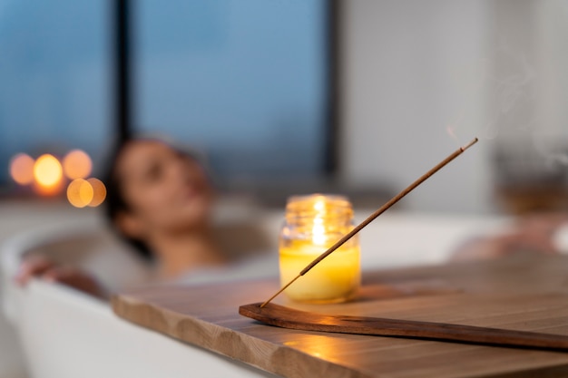 Free photo candle used by a woman to relax during a bath