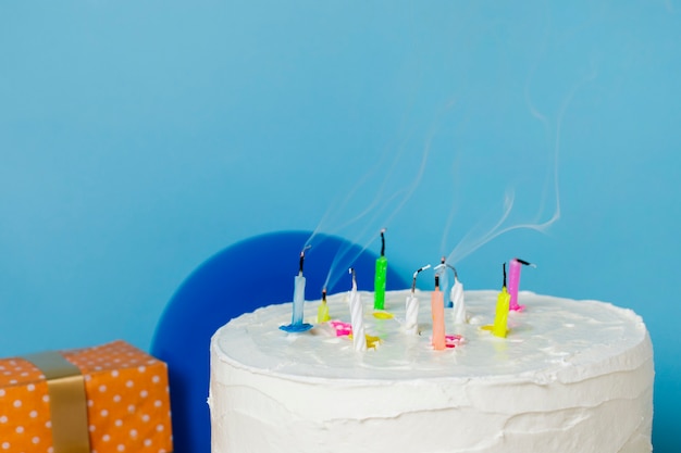 Candles on birthday cake with blue background