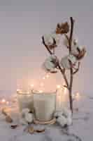 Free photo candles decorated with cotton twig and lighting equipments on marble surface