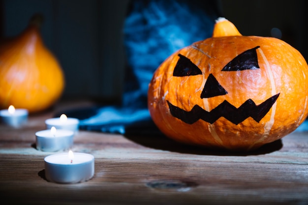 Candles and pumpkin in arrangement