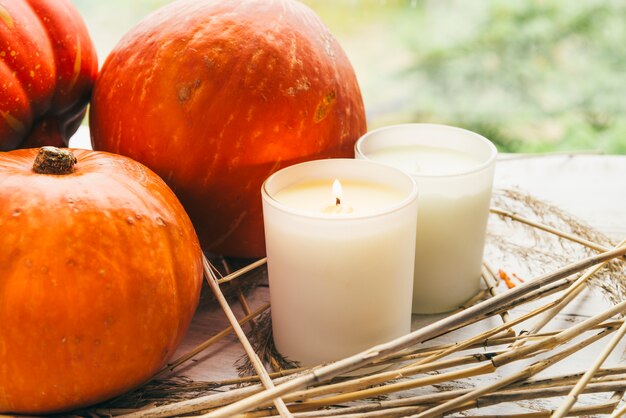 Candles and pumpkins on table