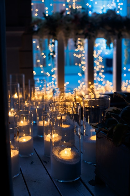 Candles shine on wooden floor in the darkness