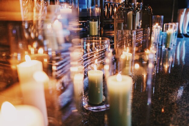 Candles in tall vases stand on the floor