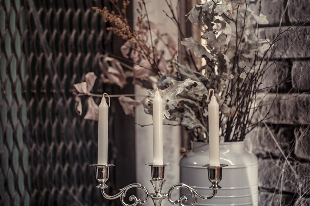 Candlestick with candles and dried flowers