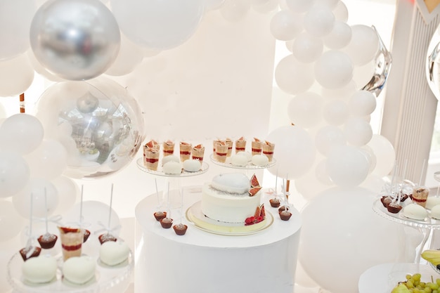 Candy bar decoration setup with delicious cakes and sweets