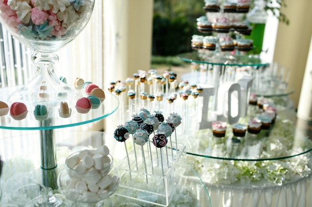 Candy bar made of tired glass dishes decorated