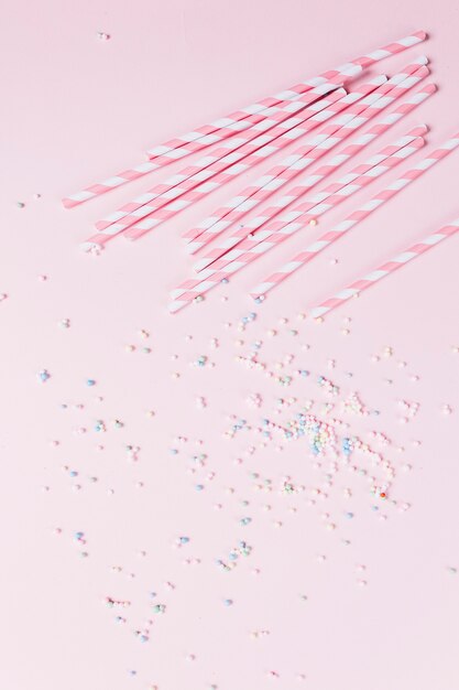 Candy cane and pestle sprinkles on pink backdrop