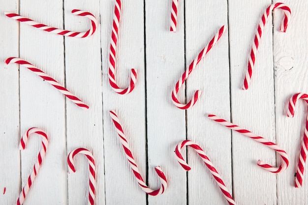 Free photo candy canes on wood board