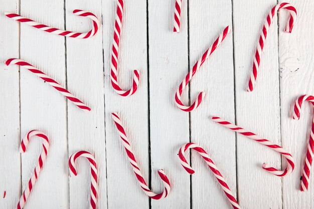 Candy canes on wood board 