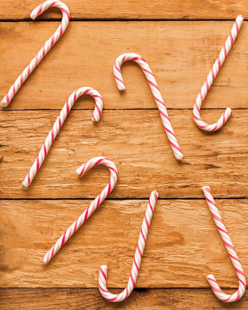 Candy canes on wood board 