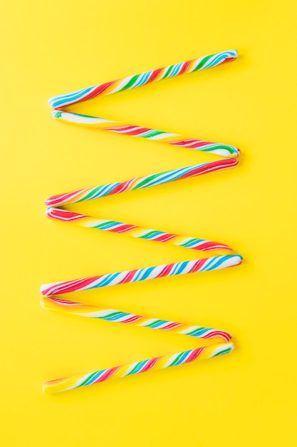 Candy canes on yellow background