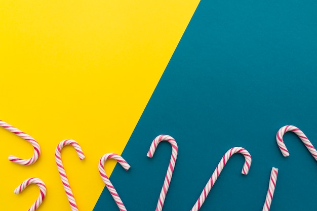 Candy canes on yellow and blue background