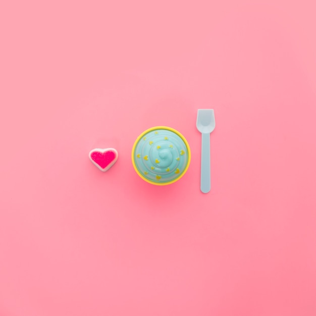 Candy heart, ice cream and plastic spoon