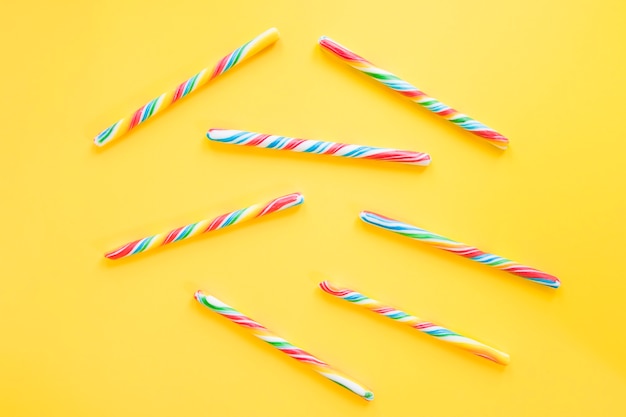 Candy sticks on yellow table