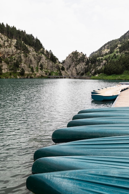 Canoe boats align on water