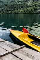 Free photo canoe floating near the wooden pier on lake