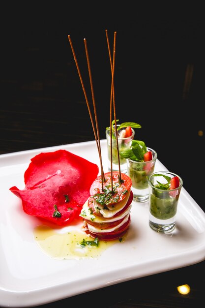 Caprese salad tomato basil mozzarella olive oil side view