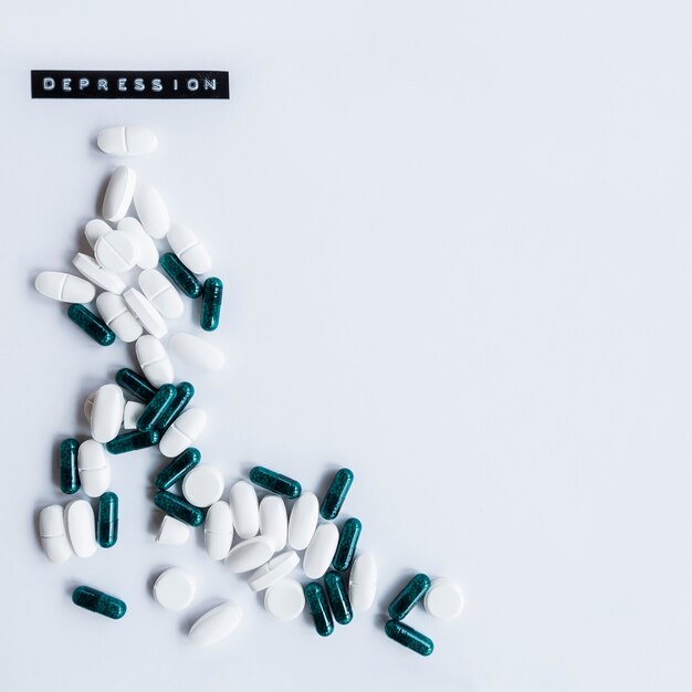 Capsules and tables with depression label on white background